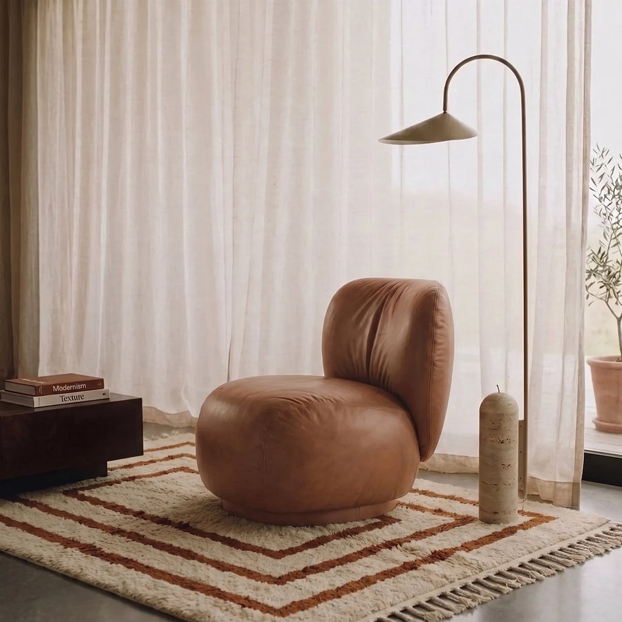 Terracotta and ivory nested frames rug in modern living room with brown leather chair