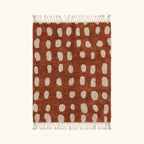 Full view of the Agdal terracotta and ivory Beni Ourain rug with an oval grid design.
