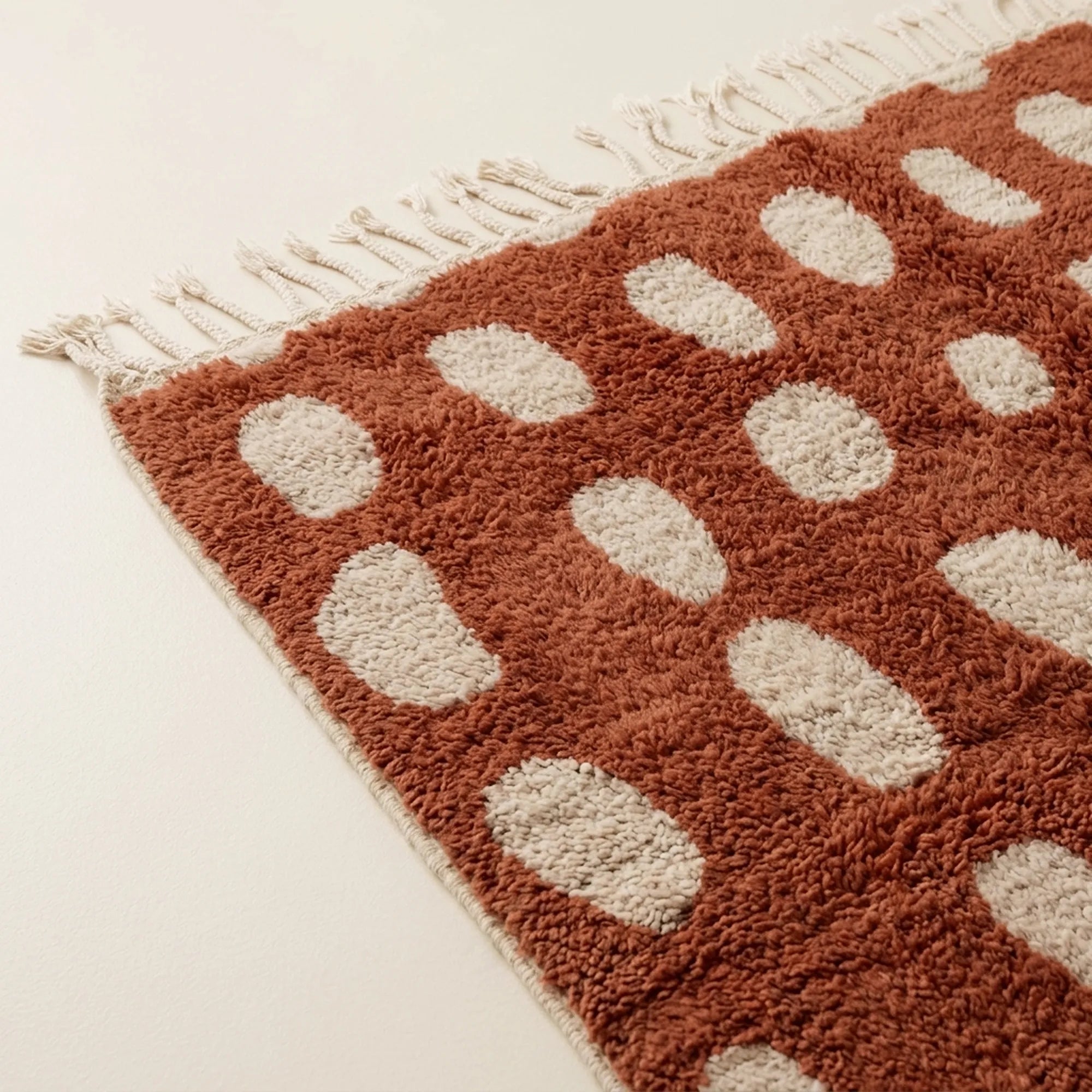 Close-up of the terracotta oval grid pattern on the Agdal ivory Beni Ourain rug.