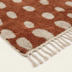 Fringe and edge detail of the Agdal terracotta and ivory Beni Ourain rug.