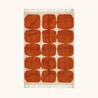 Full view of the Tifawt terracotta and ivory Beni Ourain rug with a rounded grid design.