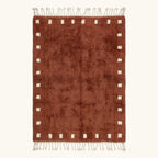 Full view of the Tazrout terracotta and ivory Beni Ourain rug with a square border design.
