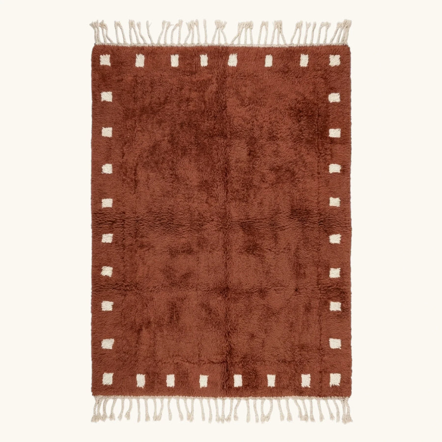 Full view of the Tazrout terracotta and ivory Beni Ourain rug with a square border design.