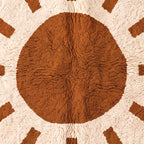 Macro detail of central sun circle and radiating rays showing hand-knotted texture on Beni Ourain wool rug