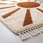 Angled view of hand-knotted wool pile showing texture and fringe detail on sun-ray Beni Ourain rug