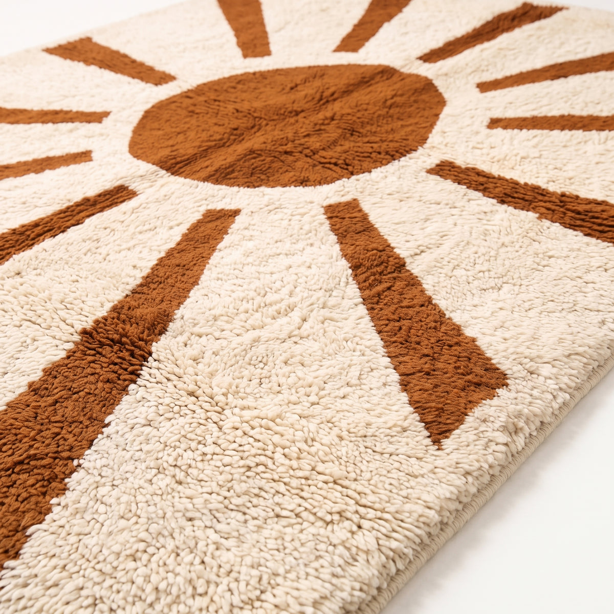 Close-up of soft hand-knotted pile texture on terracotta rays and ivory ground of sun-motif rug