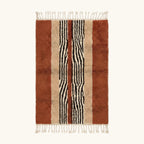Full view of the Azar terracotta, ivory and black Beni Ourain rug with a central stripe design.
