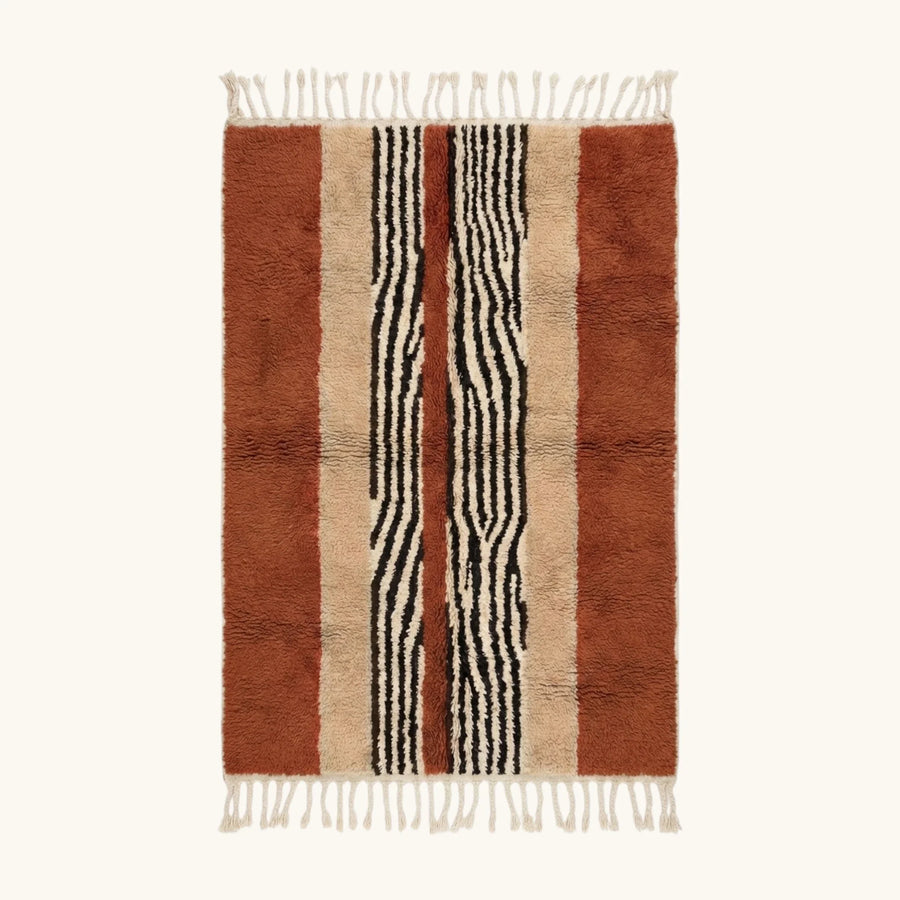 Full view of the Azar terracotta, ivory and black Beni Ourain rug with a central stripe design.
