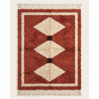 Terracotta and ivory Boujaad rug with three stacked diamond motifs and black separators, plain background
