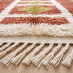 Texture detail showing dense hand-knotted wool pile and fringe edge of Mrirt rug