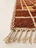 Cream wool fringe edge and corner detail of terracotta and rust Mrirt runner