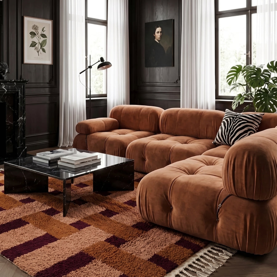 Terracotta and wine checked grid Mrirt rug layered in modern living room with cognac leather sofa and black coffee table