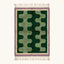 Full view of the Tifawt Beni Ourain rug with forest-green and sage abstract forms, an ivory border and lavender trim.