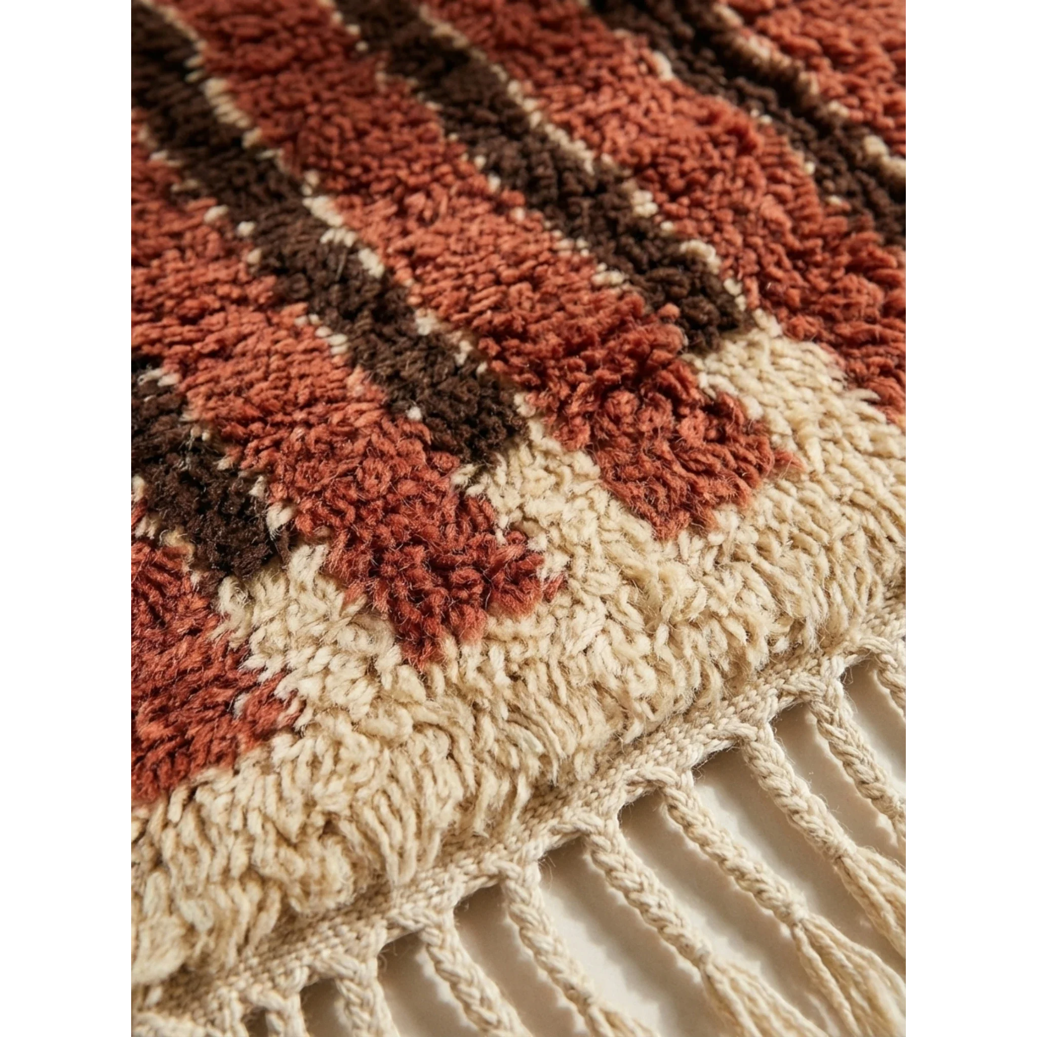 Hand-tied fringe and wool pile detail of the Tifrit terracotta rug.