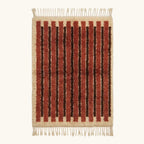 Full view of the Tifrit terracotta Beni Ourain rug with linear stripes and hand-tied fringe.