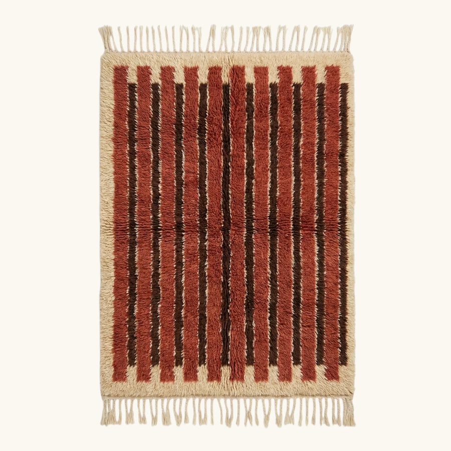 Full view of the Tifrit terracotta Beni Ourain rug with linear stripes and hand-tied fringe.