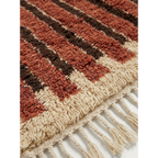 Close-up of the terracotta and ivory linear pattern on the Tifrit Beni Ourain rug.