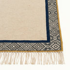 Ivory, charcoal and navy Zanafi rug Tighremt with tribal geometric border, border and fringe detail