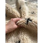 Soft hand-knotted ivory Atlas wool pile of the Tislit Beni Ourain rug.