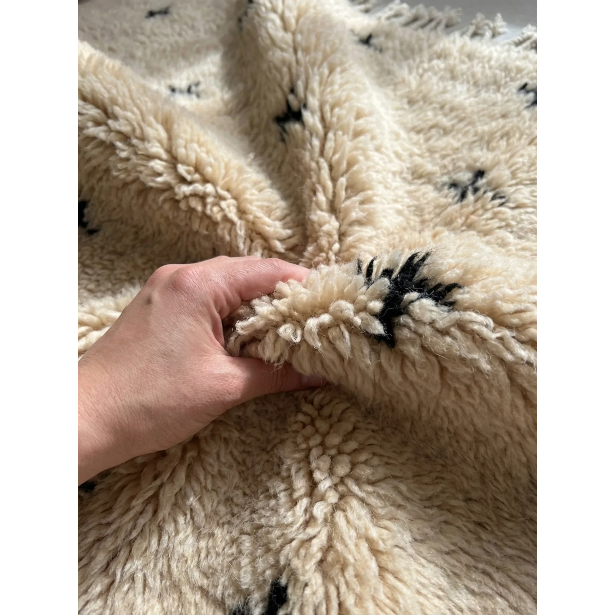 Soft hand-knotted ivory Atlas wool pile of the Tislit Beni Ourain rug.