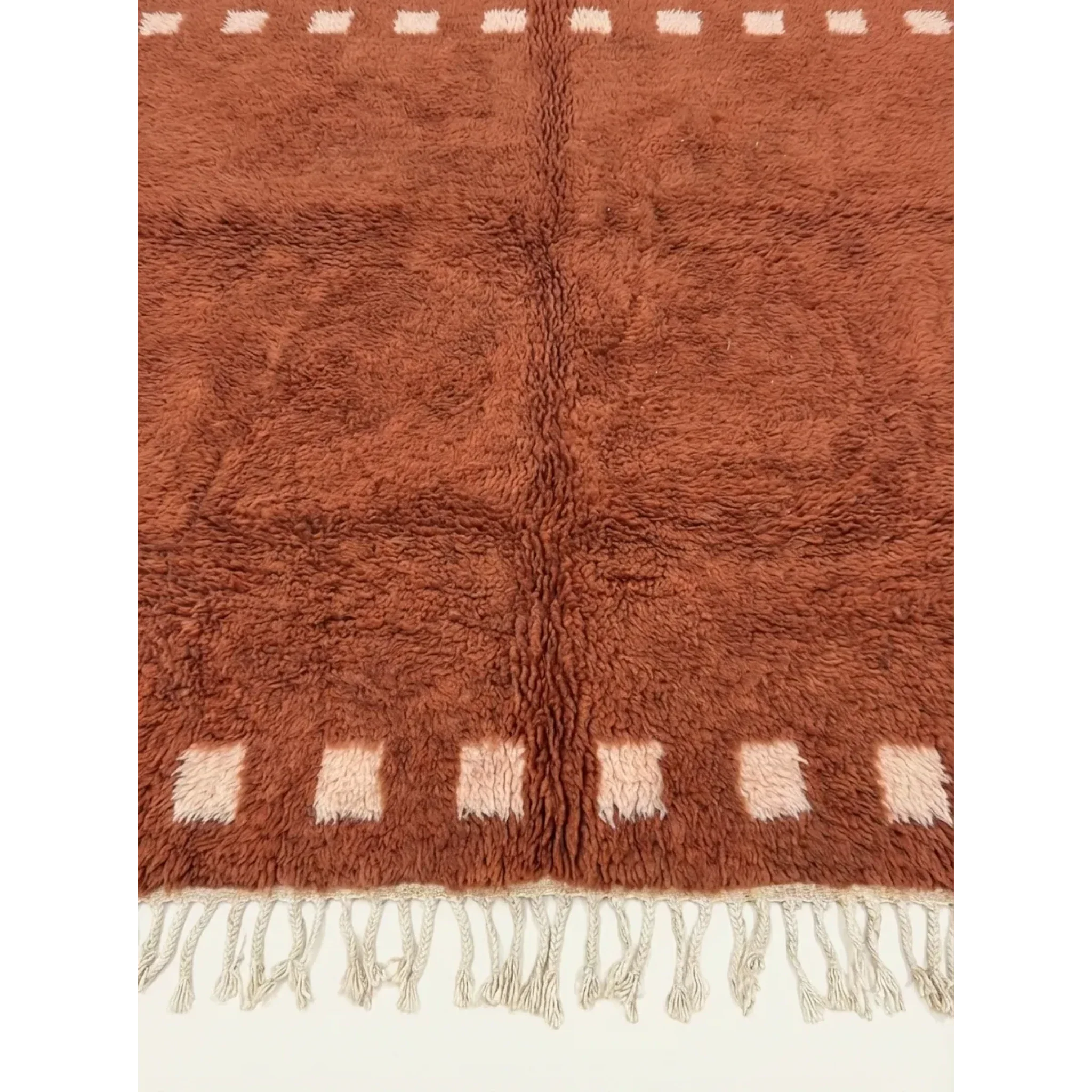 Hand-tied fringe and plush Atlas wool detail of the Tiziri terracotta rug.