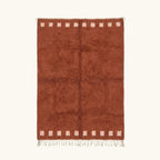 Full view of the Tiziri terracotta Beni Ourain rug with a warm border block motif and hand-tied fringe.
