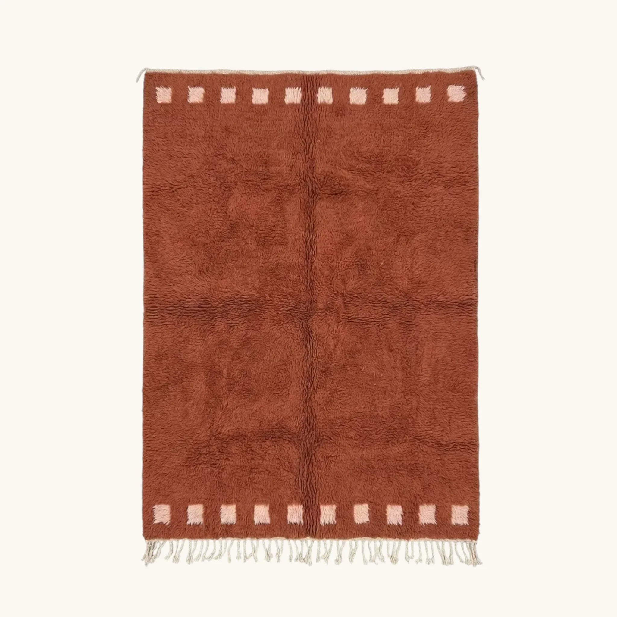 Full view of the Tiziri terracotta Beni Ourain rug with a warm border block motif and hand-tied fringe.