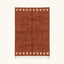 Full view of the Tiziri terracotta Beni Ourain rug with a warm border block motif and hand-tied fringe.