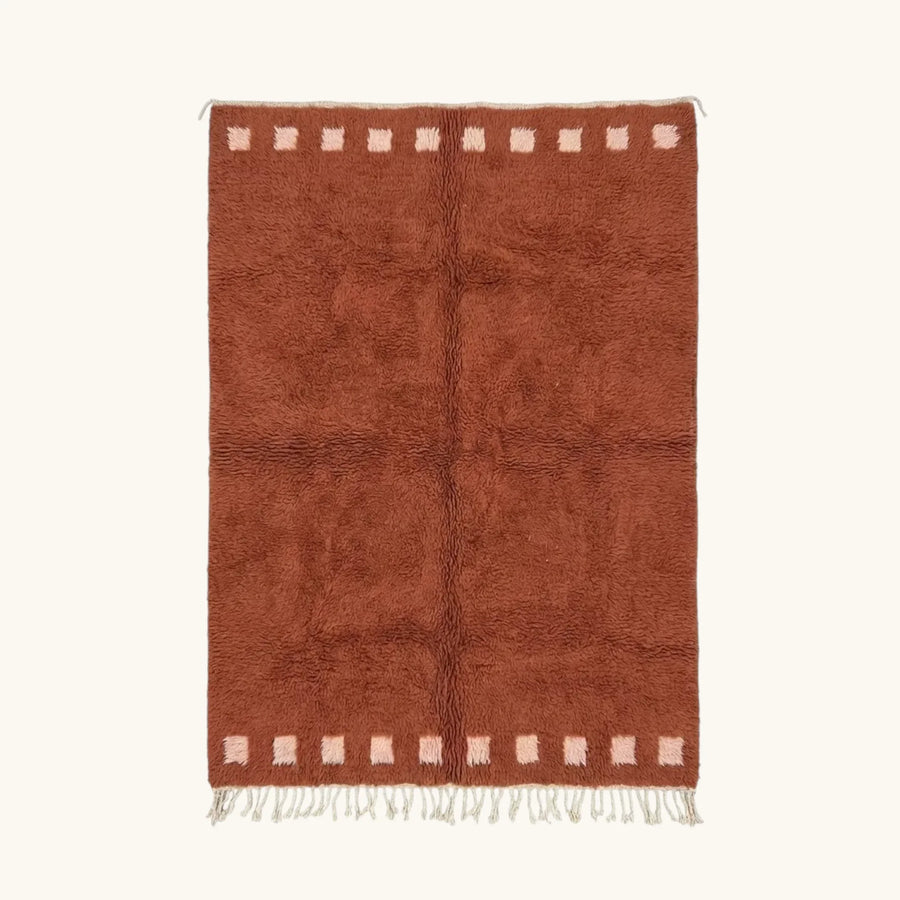 Full view of the Tiziri terracotta Beni Ourain rug with a warm border block motif and hand-tied fringe.