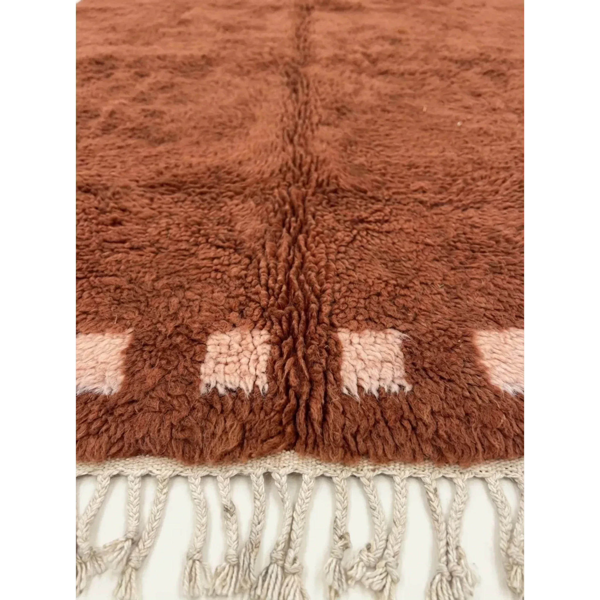 Close-up of the terracotta and ivory border block motif on the Tiziri rug.