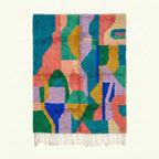 Full view of the Taziri turquoise, coral and lilac Boujaad rug with an abstract color-block design.