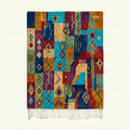 Full view of the Amadal turquoise, ochre and burgundy Boujaad rug with a vertical patchwork diamond design.
