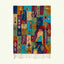 Full view of the Amadal turquoise, ochre and burgundy Boujaad rug with a vertical patchwork diamond design.