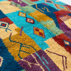 Close-up of the natural wool pile and woven texture of the Amadal Boujaad rug.