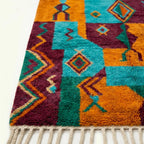 Border and edge detail of the Azru Boujaad rug in turquoise and orange.