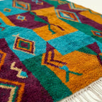 Detail view of the Azru Boujaad rug showing its colorful handwoven pattern.