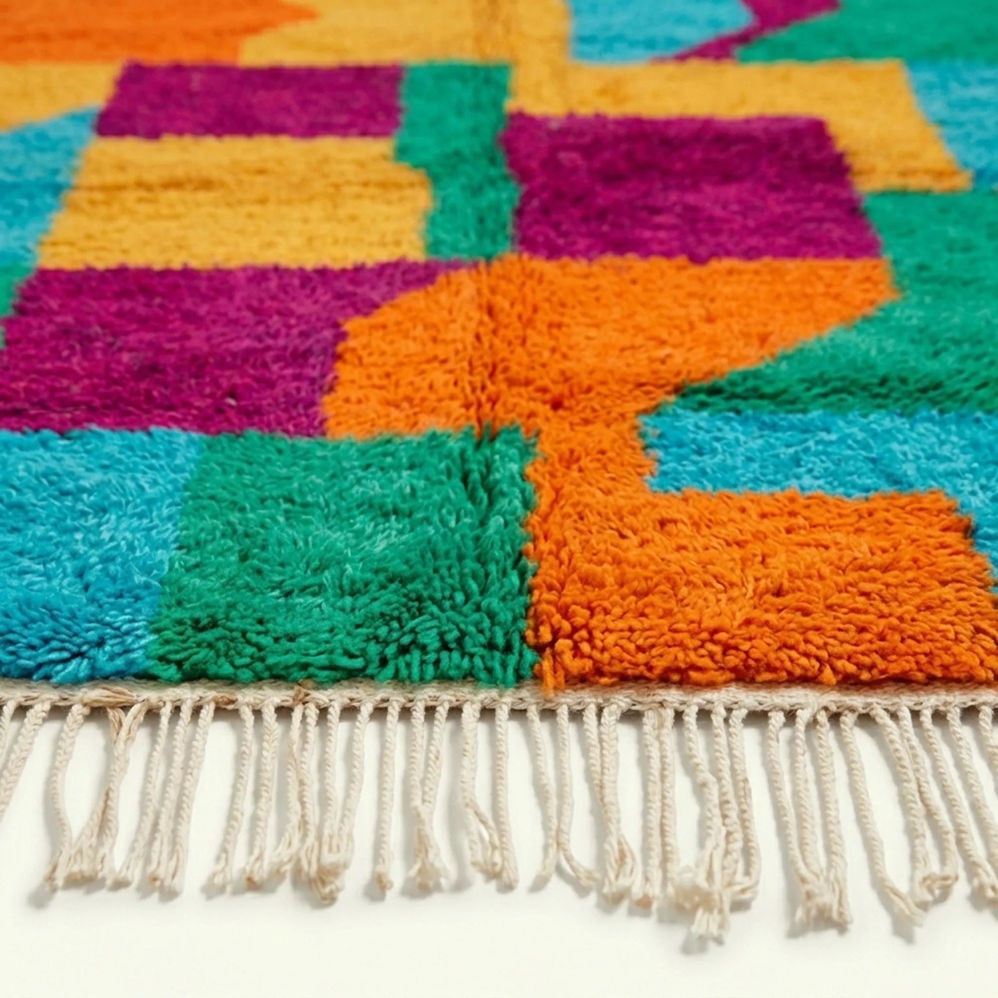 Border and edge detail of the Itri Boujaad rug in turquoise and orange.