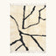 Full view of the Inur warm ivory and black Beni Ourain rug with a branch line design.