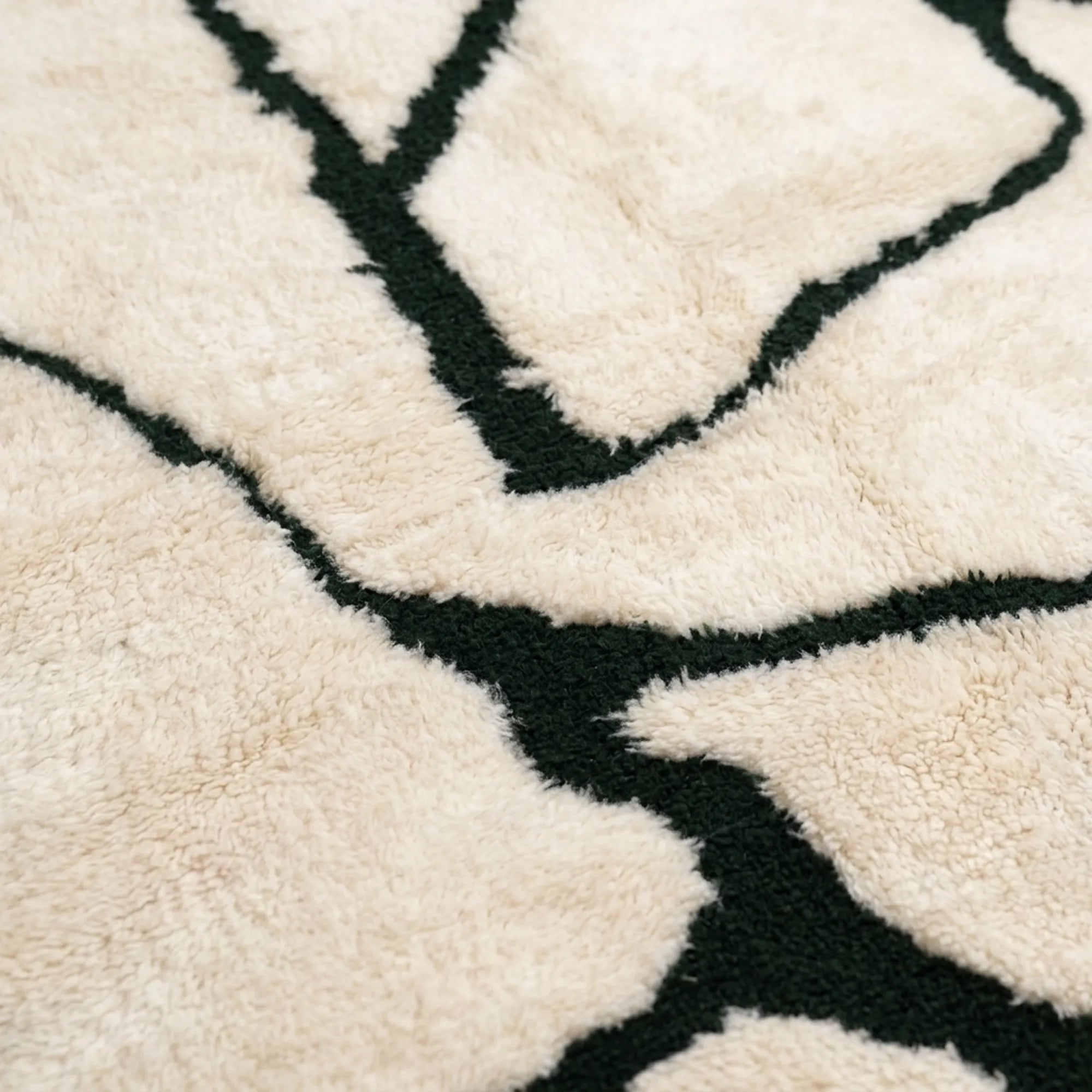 Additional close view of the branch line motif on the Inur warm ivory and black Beni Ourain rug.