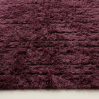 Close-up of wine Beni Ourain pile texture showing dense wool weave and tonal depth